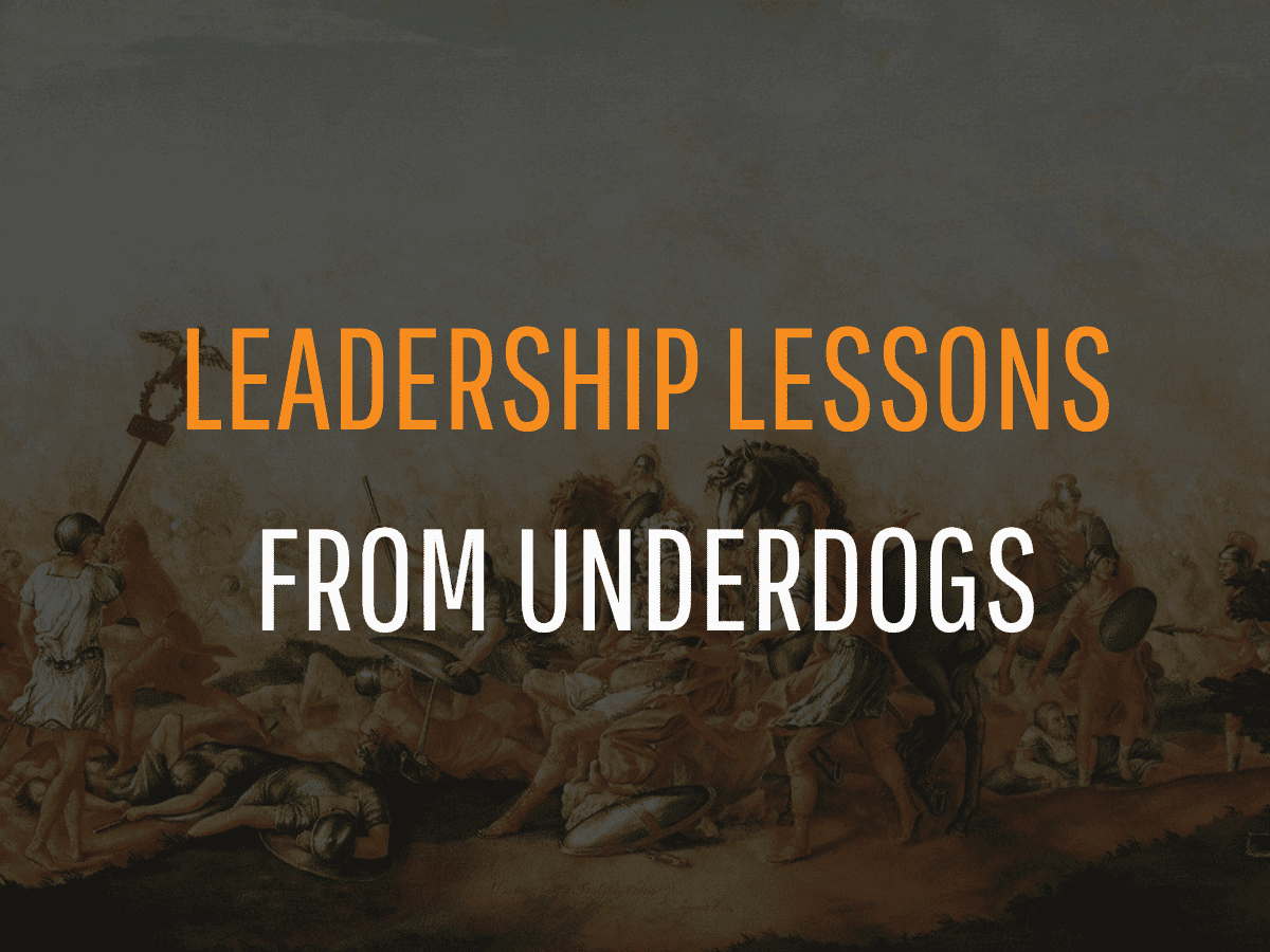 A dramatic historical painting serves as the background for text in bold orange and white letters that reads, "Leadership Lessons From Underdogs." The artwork vividly depicts a battle scene filled with warriors and fallen soldiers.