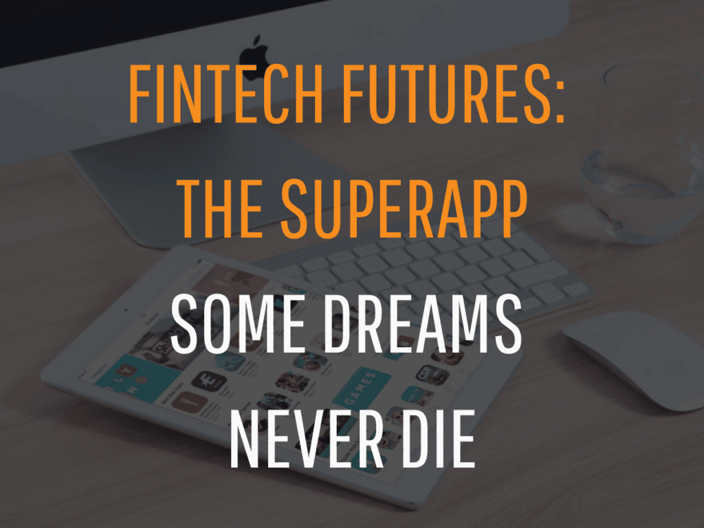 A desktop setup with a blurred background features an iPad loaded with apps. Overlaid in bold text are the words "Fintech Futures: The Superapp - Some Dreams Never Die." The scene includes a keyboard and a mouse, with a glass of water in the background, highlighting the versatility of the Superapp.