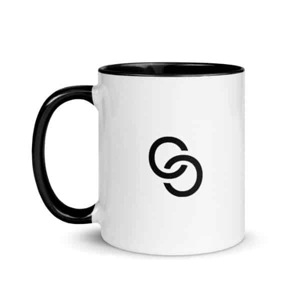 A white ceramic coffee mug with a black handle and a black interior adds an elegant touch. The minimalist design features two interlocking black circles on one side, making this Mug with Color Inside both stylish and functional.